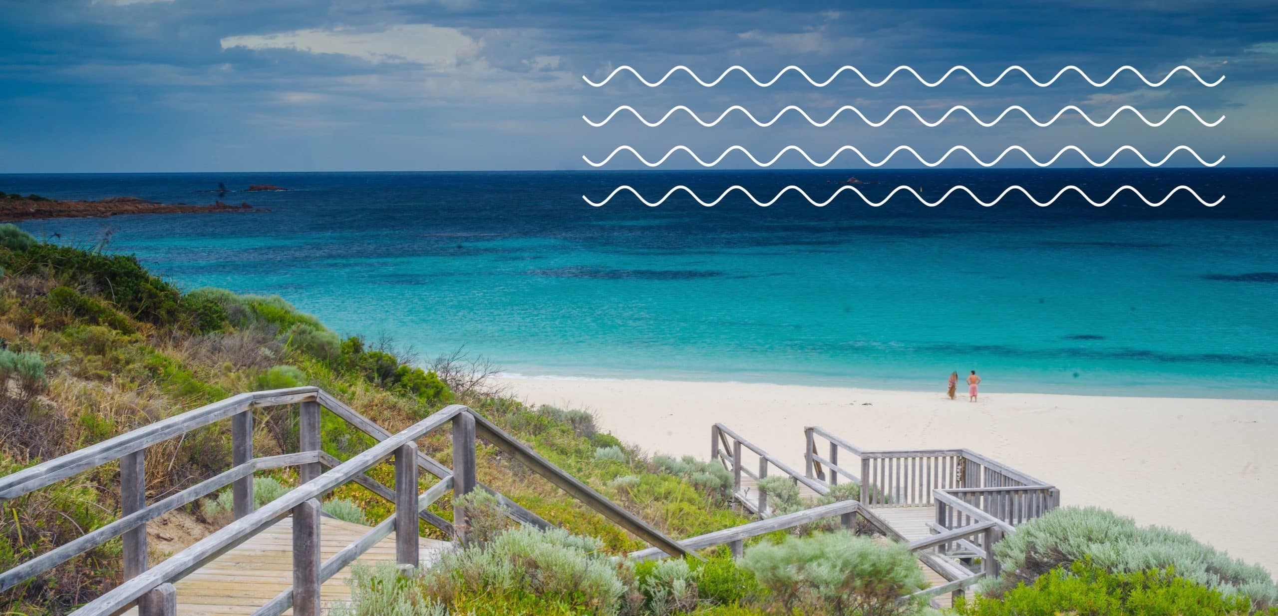Wooden walkway leading to serene beach and ocean