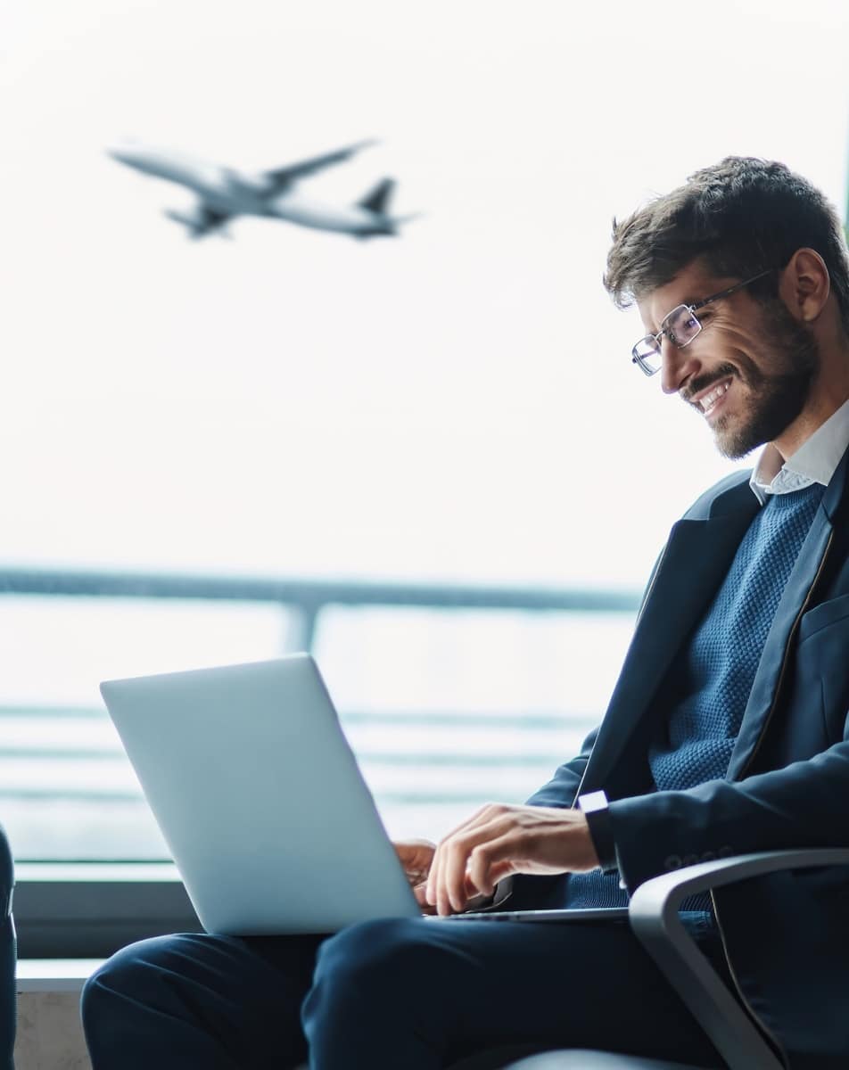 Man working on laptop at airport