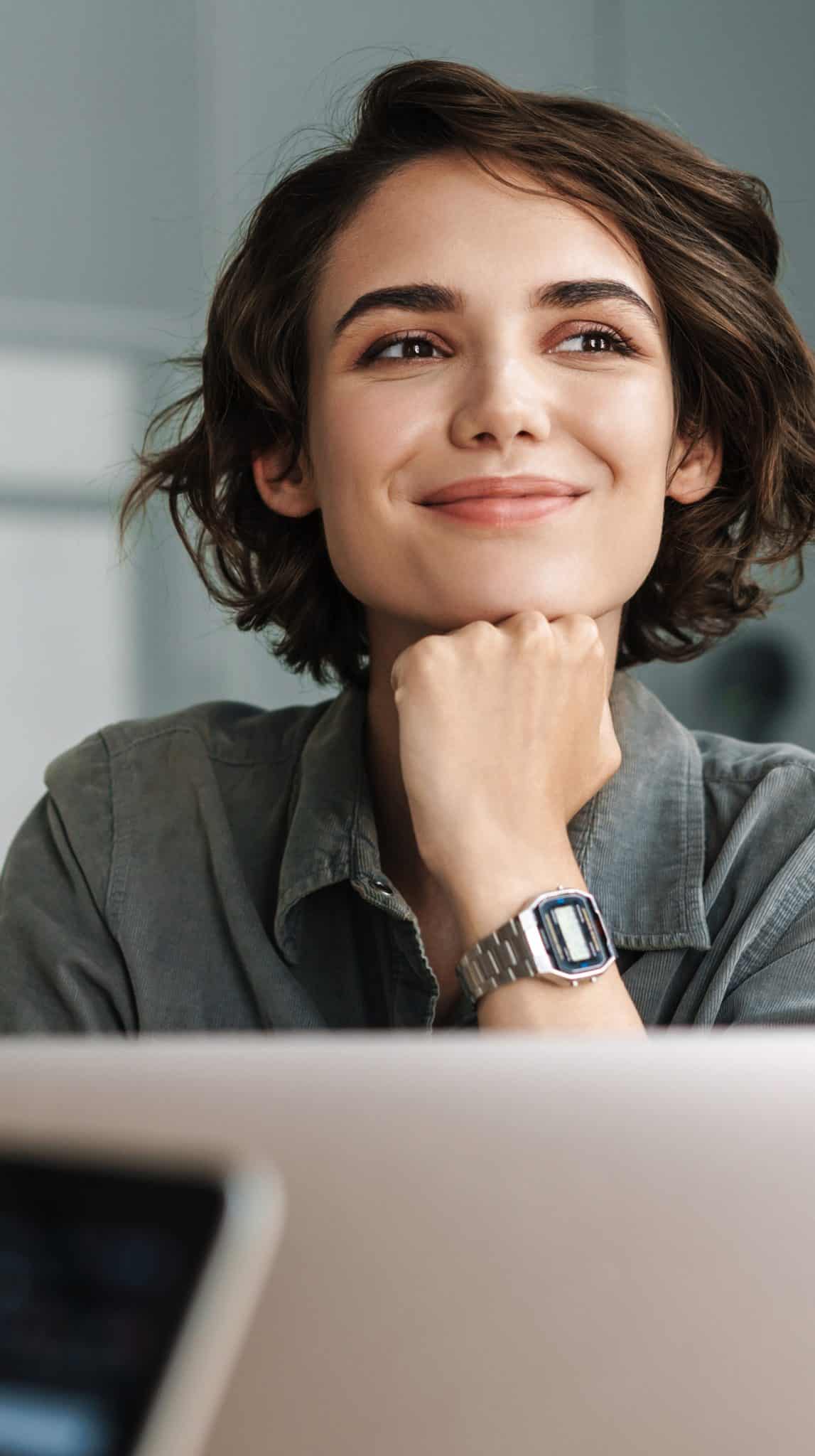 Woman smiling, thoughtful, in casual attire