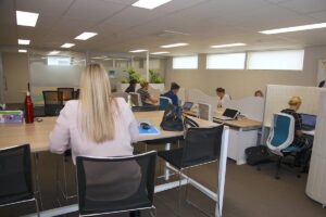Coworking space with people working on laptops.