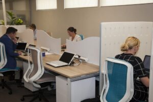 Office space with people working on laptops